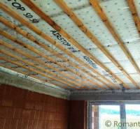 Ceiling insulation and construction in a family house, wooden beams and masonry.