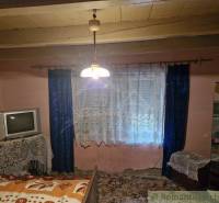Interior of a traditional room, television, curtain, family house, rustic atmosphere, warm colors.