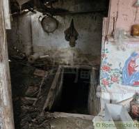 An abandoned room in a family house with a well and a religious painting.