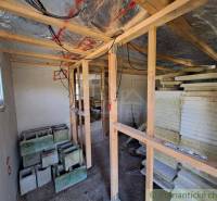 Construction of a small cabin, wooden structures, insulation, bricks waiting to be used.