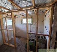 Interior renovation, wooden frames, and a cabin. Construction materials and electrical installations are visible.