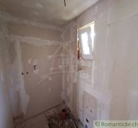 A construction room under renovation with a window, suitable for remodeling in a cottage.