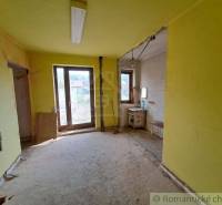 Interior of a family house with yellow walls, an empty room, and a countryside view.