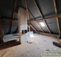 The attic of a family house with wooden beams and a skylight. Romantic cottages.