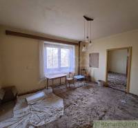 Empty room, chairs and a table by the window, yellow walls, family house.