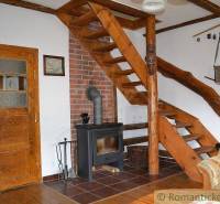 Wooden stairs, antique fireplace, natural interior, and rustic family house create a cozy space.