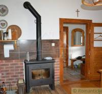 Fireplace in the kitchen, classic design, part of a family house with an antique touch.