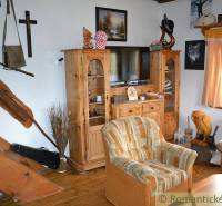Wooden furniture in the living room with a staircase and a family house creates a cozy atmosphere.