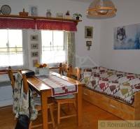 A cozy kitchen in a family house with wooden furniture and traditional decoration.