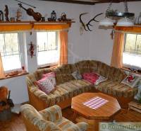 Living room in rustic style with a corner sofa and rustic decorations in a family house.