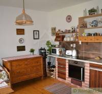 A kitchen corner in a family house with wooden furniture and kitchen appliances.