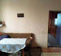 A family house with a rustic interior, retro furniture and decor, dining table in the corner.