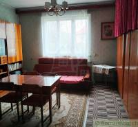 Living room in a family house with old furniture, carpet on the floor, window.