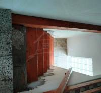 Staircase with railing in a family house, door, wall, and ceiling. Thermal insulation.