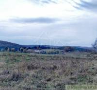 A rural region with meadows, hills, and rural buildings. Ideal for gardens and relaxation.