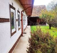 A family house with a wooden roof, garden, tree; a natural environment for a peaceful life.