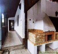 A family house with a terrace and a fireplace offers outdoor relaxation and comfort.