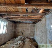 Renovation of an old family house: exposed wooden beams and stone walls.