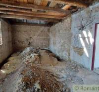 Renovation of a family house, bare walls and floor, window, door to a bright room.