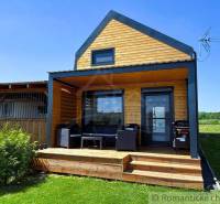 A cottage in the village of Jakubov with a garden and a wooden seating terrace.