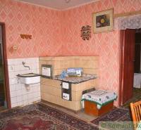 Retro kitchen with a stove, sink, and decorations in a family house.