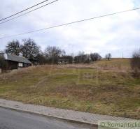 The image shows agricultural and forest land with rural landscape and the edge of a village.