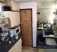 A kitchen in a family house with white cabinets, a stove, and cooking equipment.