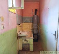 Cozy bathroom with a sink in a family house, colorful walls, older boiler.