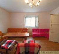 Living room in a family house with sofas, a table, and comfortable armchairs.