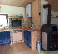 A traditional cottage with a wooden kitchen, warmth from the stove, and original decorations.