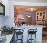 Interior of a family house: kitchen, bar stools, wall decorations.