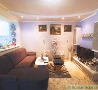 Living room of a family house with a comfortable sofa, television, and decorative details.