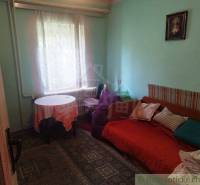 A room with a bed, a picture, and a blanket, a family house, cozy interior.