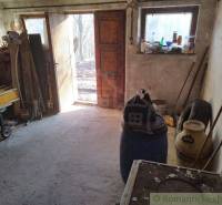 Wooden cabin with access to a terrace, rustic atmosphere, and space for tools.