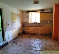 An abandoned room in a cabin with colorful walls without furniture, waiting for renovation.