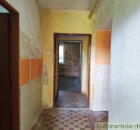 Cottage with an older interior, transitional room, colorful walls, tiles, visible wear.