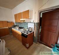 A country kitchen with wooden furniture and appliances in a family house.