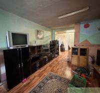 A family house with wooden flooring, a fireplace, and a retro television, a cottage with rustic furnishings.