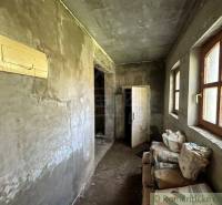 Interior with plastered walls, plastic windows, cement bags, and doors. Cottage renovation.