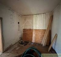 Older interior for renovation, cottage with OSB boards and wood.