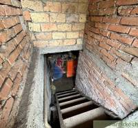 Old brick stairs leading to the basement and a family house, boiler, bricks.