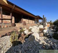 A family house with a stone garden, decorative pots, and traditional architectural elements.