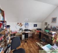 Home office with an attic, a desk, and floral decorations in a family house.