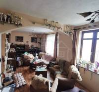 A family house with a living room full of trophies and cozy furnishings on a wooden floor.
