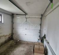 A garage with boxes and a radiator in a family house needs maintenance.