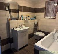 Bathroom with a bathtub, sink, and toilet in a family house.