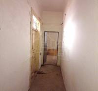 Narrow, closing hallway, door leading to a room, walls in a family house.
