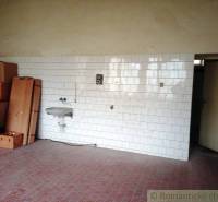 Interior with a tiled wall, a sink, and cardboard boxes, suitable for a family house.