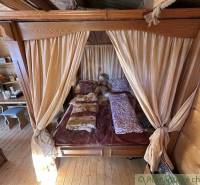 Rustic interior with a bed, curtain, wooden furniture, family house.