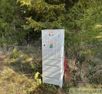 An electrical box near the forest close to a family house, suitable for nature.